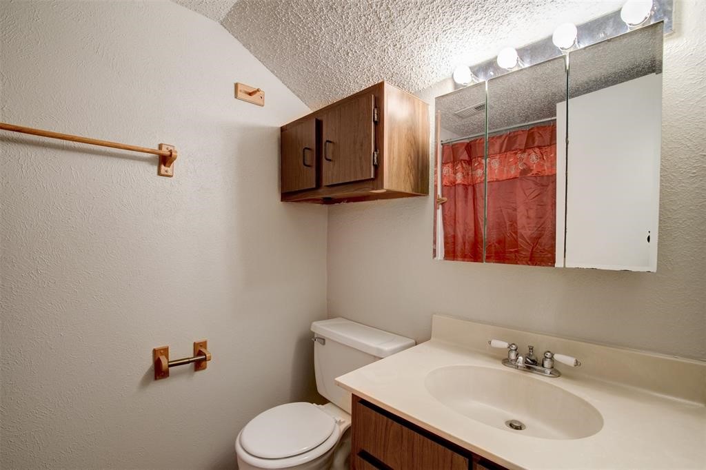 12900 Walden Road, Unit 202B Montgomery, TX 77356 - Photo 24 of 30 a bathroom with a sink vanity mirror and toilet