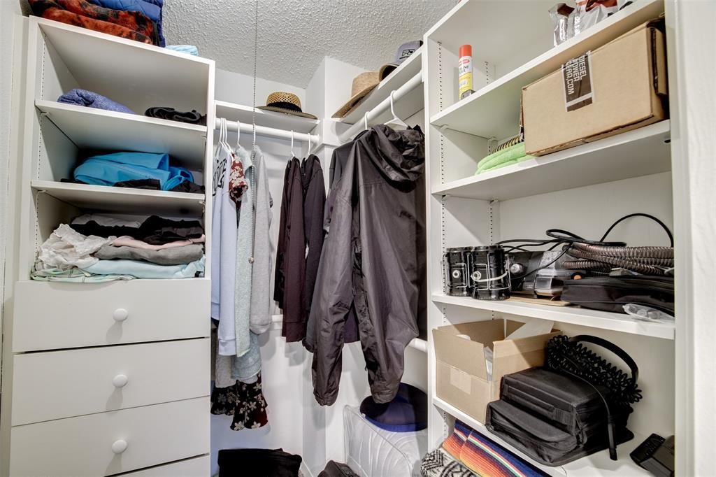 12900 Walden Road, Unit 202B Montgomery, TX 77356 - Photo 25 of 30 a view of walk in closet with clothes and shoes