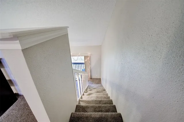 a view of a hallway with a stairs