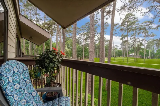 a view of a porch with chairs and a yard