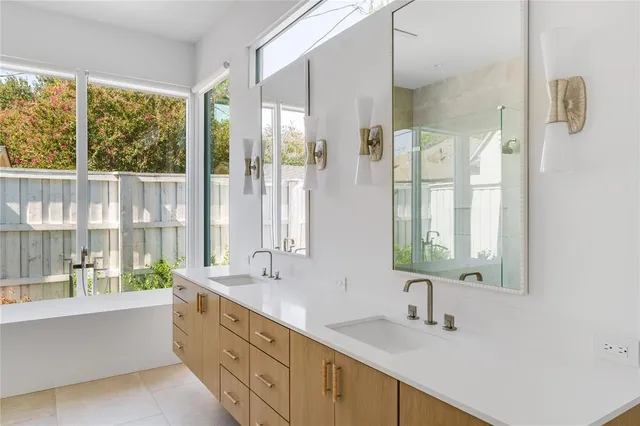 a bathroom with a double vanity sink and a large mirror