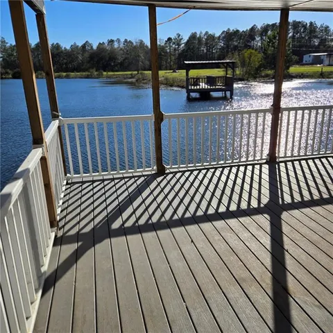 a view of balcony with wooden floor and outdoor seating