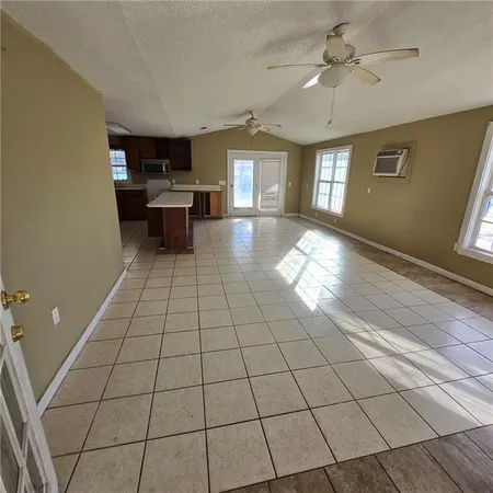 a view of a livingroom with kitchen and furniture