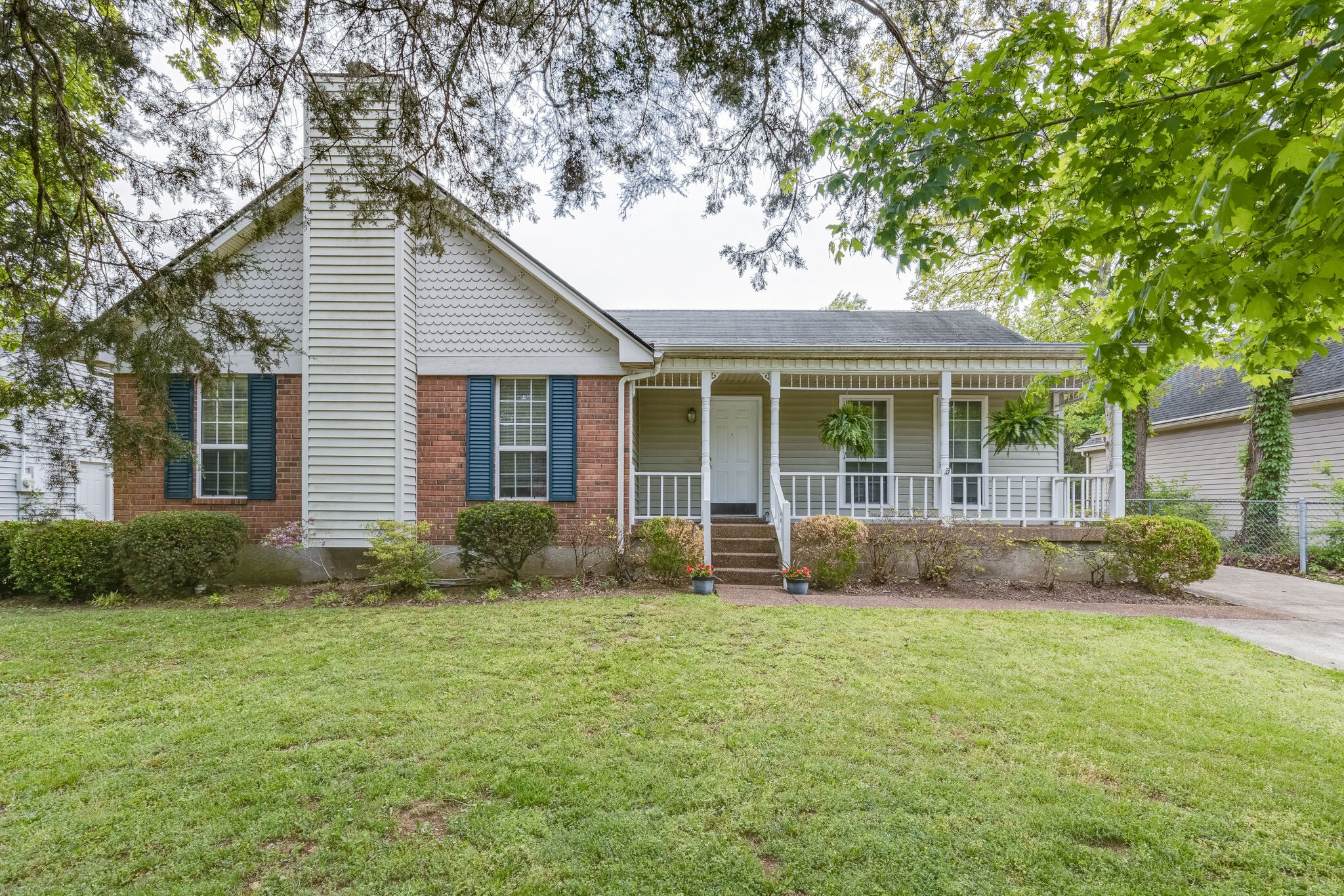 a front view of a house with garden and porch