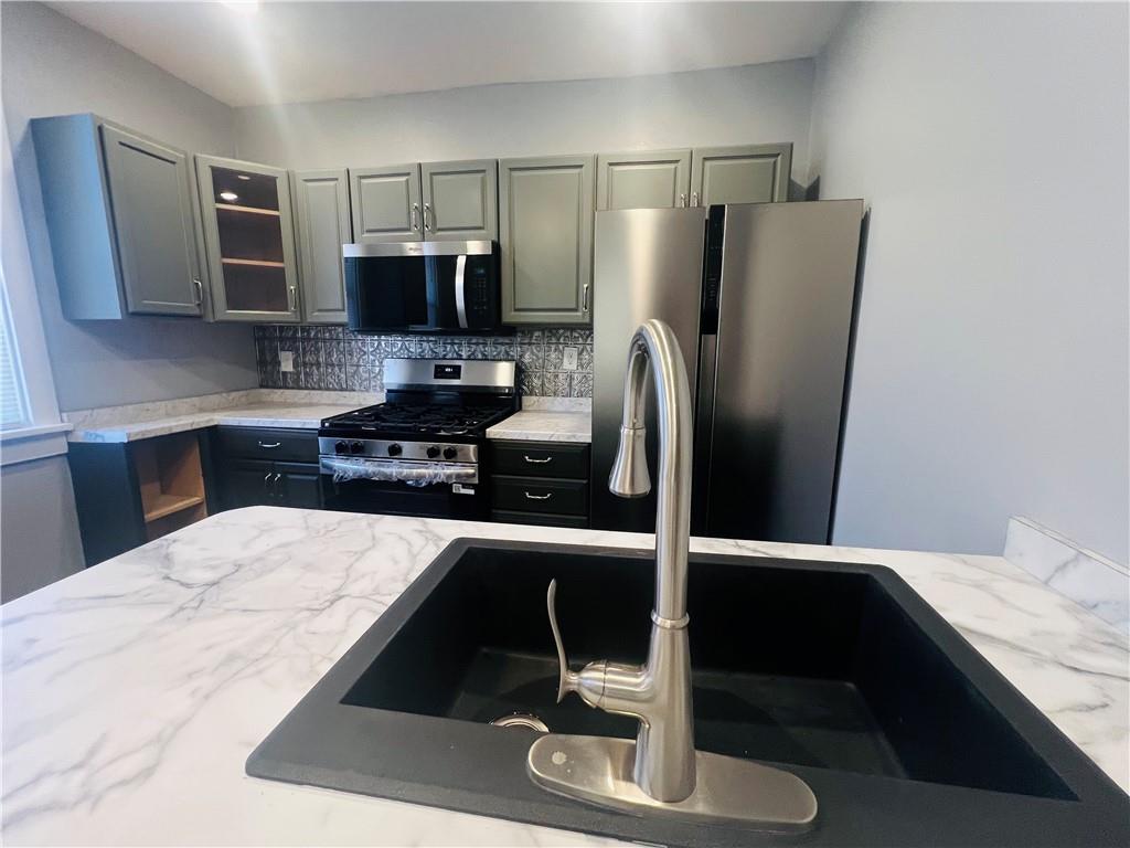 262 Adams Street Pittsburgh, PA 15221 - Photo 11 of 26 a kitchen with a refrigerator and a sink