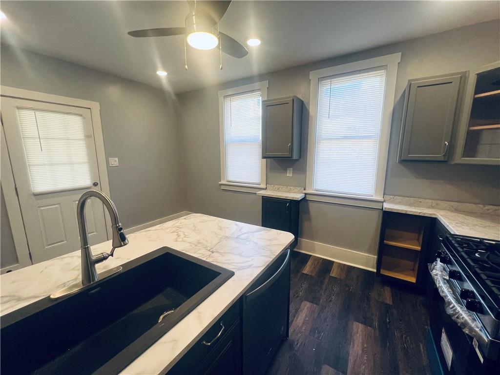 262 Adams Street Pittsburgh, PA 15221 - Photo 9 of 26 a kitchen with a sink cabinets and wooden floor
