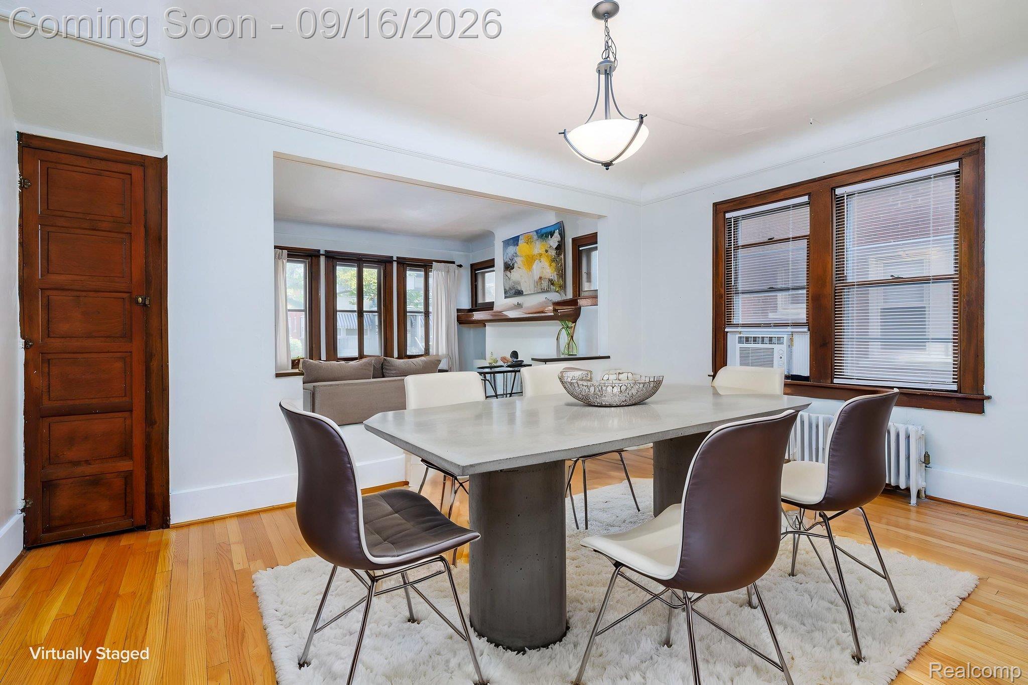 999 Nottingham Road Grosse Pointe, MI 48230 - Photo 12 of 30 Hardwood flooring, wood-paneled door, recessed living area, wood-trimmed windows, and ceiling-mounted light fixture