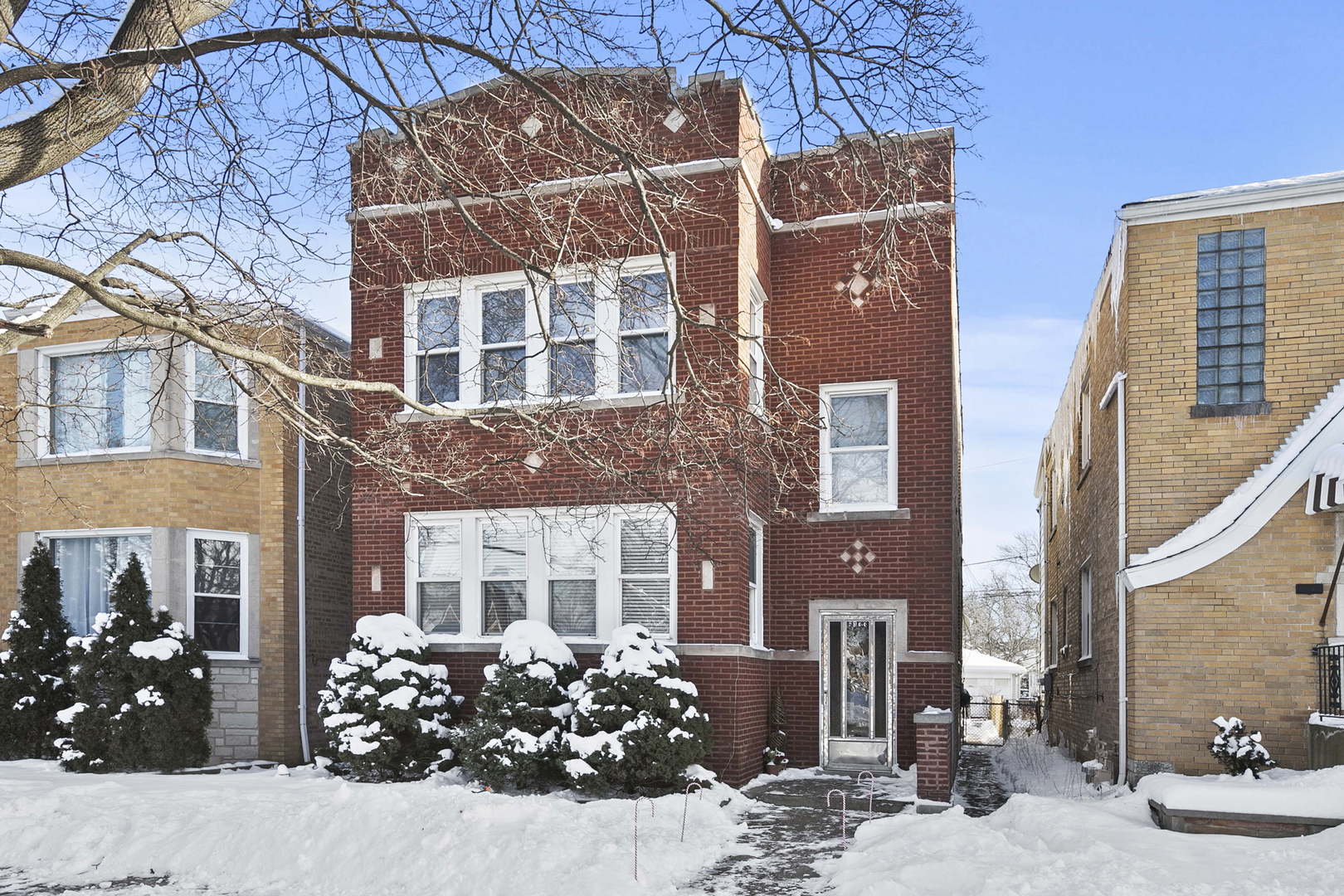 6133 West Rosedale Avenue Chicago, IL 60646 - Photo 10 of 11 front view of a brick house with a large windows