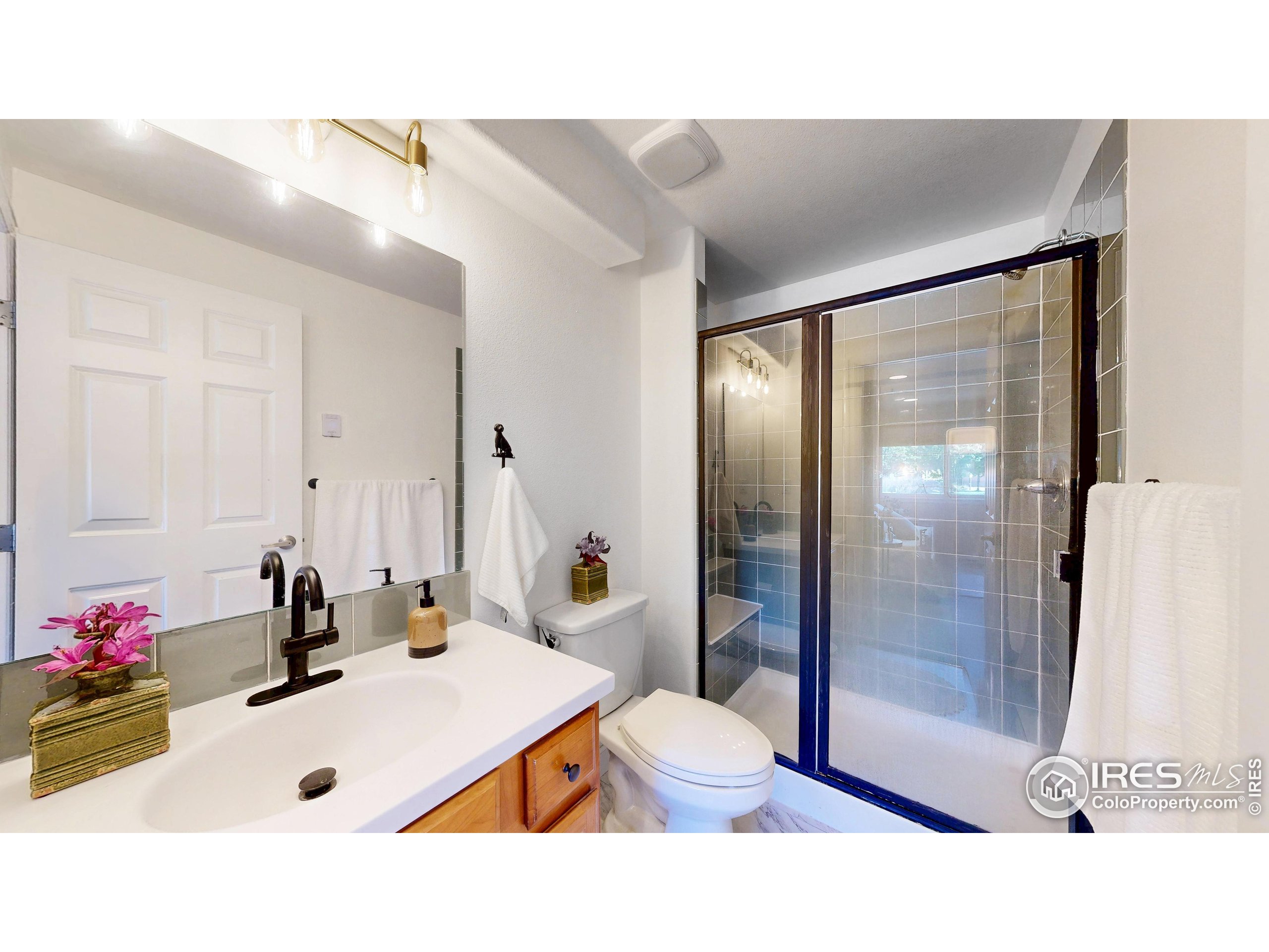 214 Willow Street, Unit 1 Fort Collins, CO 80524 - Photo 24 of 48 a bathroom with a sink mirror vanity and toilet