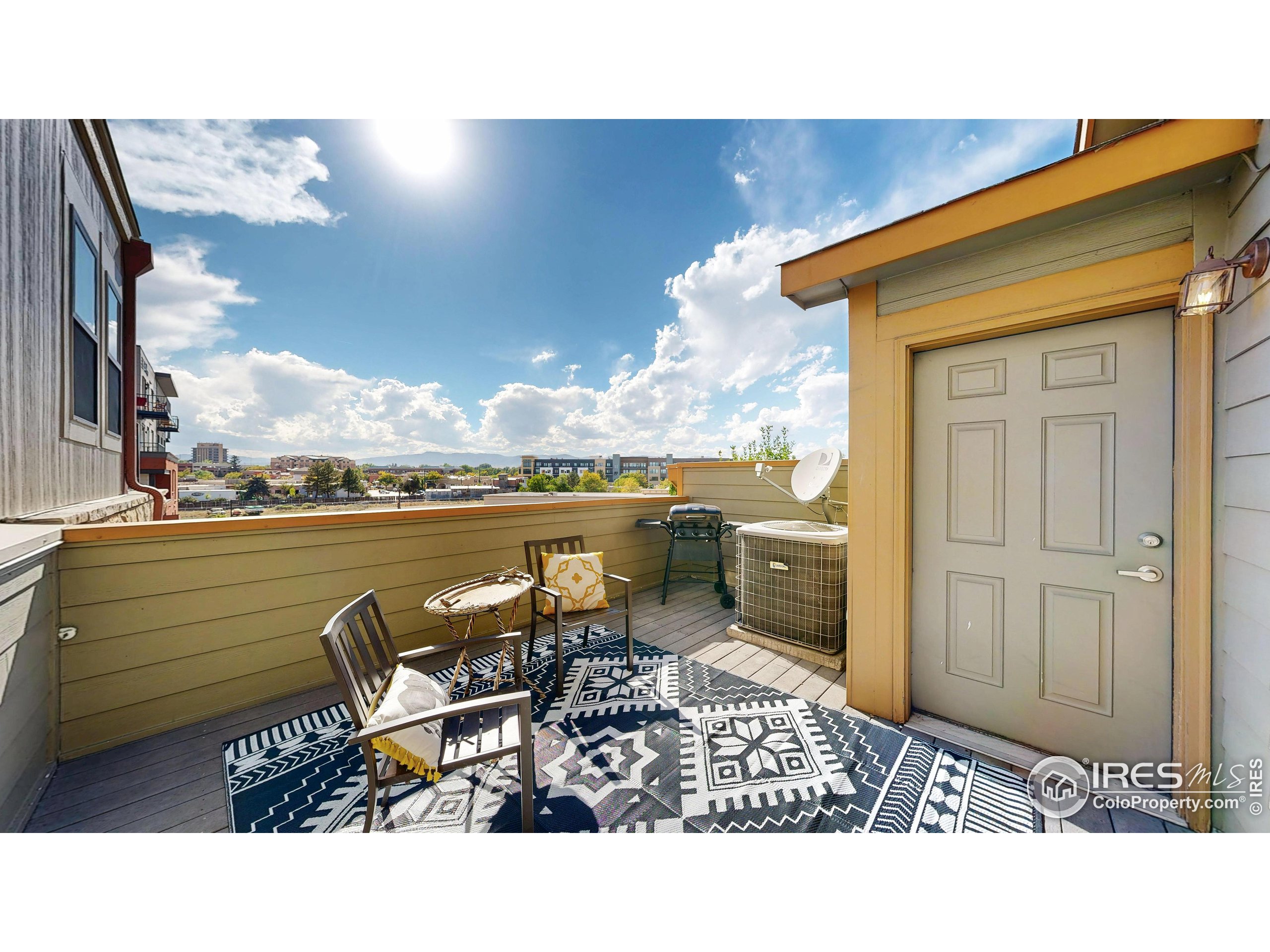214 Willow Street, Unit 1 Fort Collins, CO 80524 - Photo 32 of 48 a balcony with chairs and view of city view