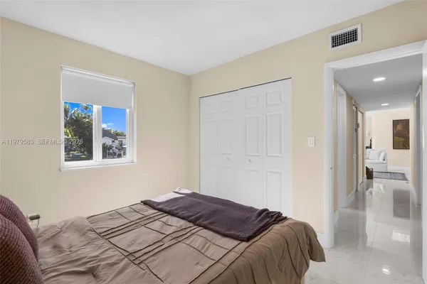 a bedroom with a bed and a painting on the wall