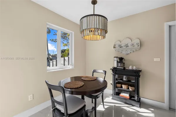 a view of a dining room with furniture and chandelier