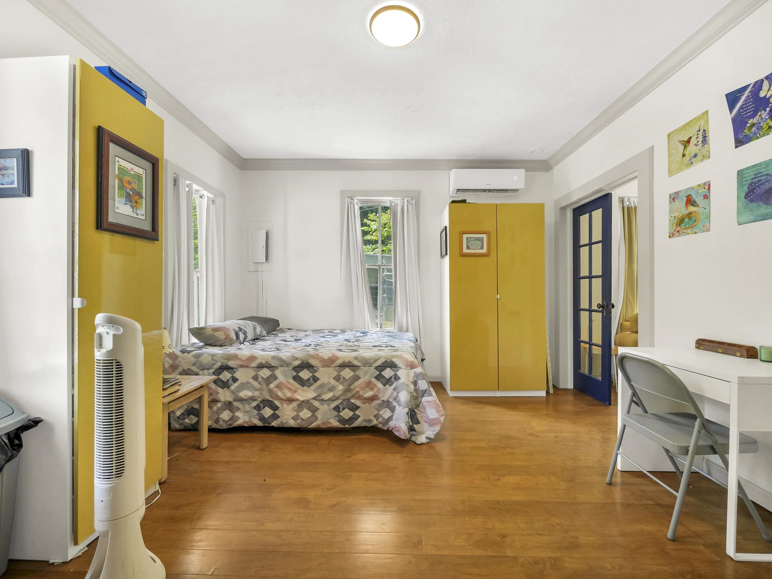 8 Davis Street St. Augustine, FL 32084 - Photo 13 of 36 a bedroom with a bed and wooden floor