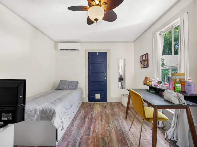 a bedroom with furniture and a wooden floor