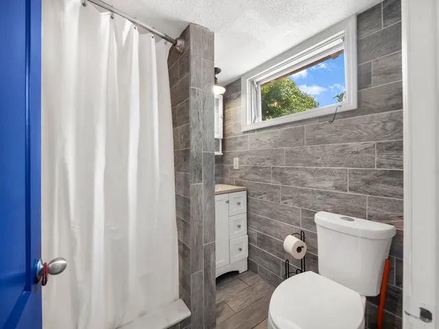 a white toilet sitting next to a bathroom sink