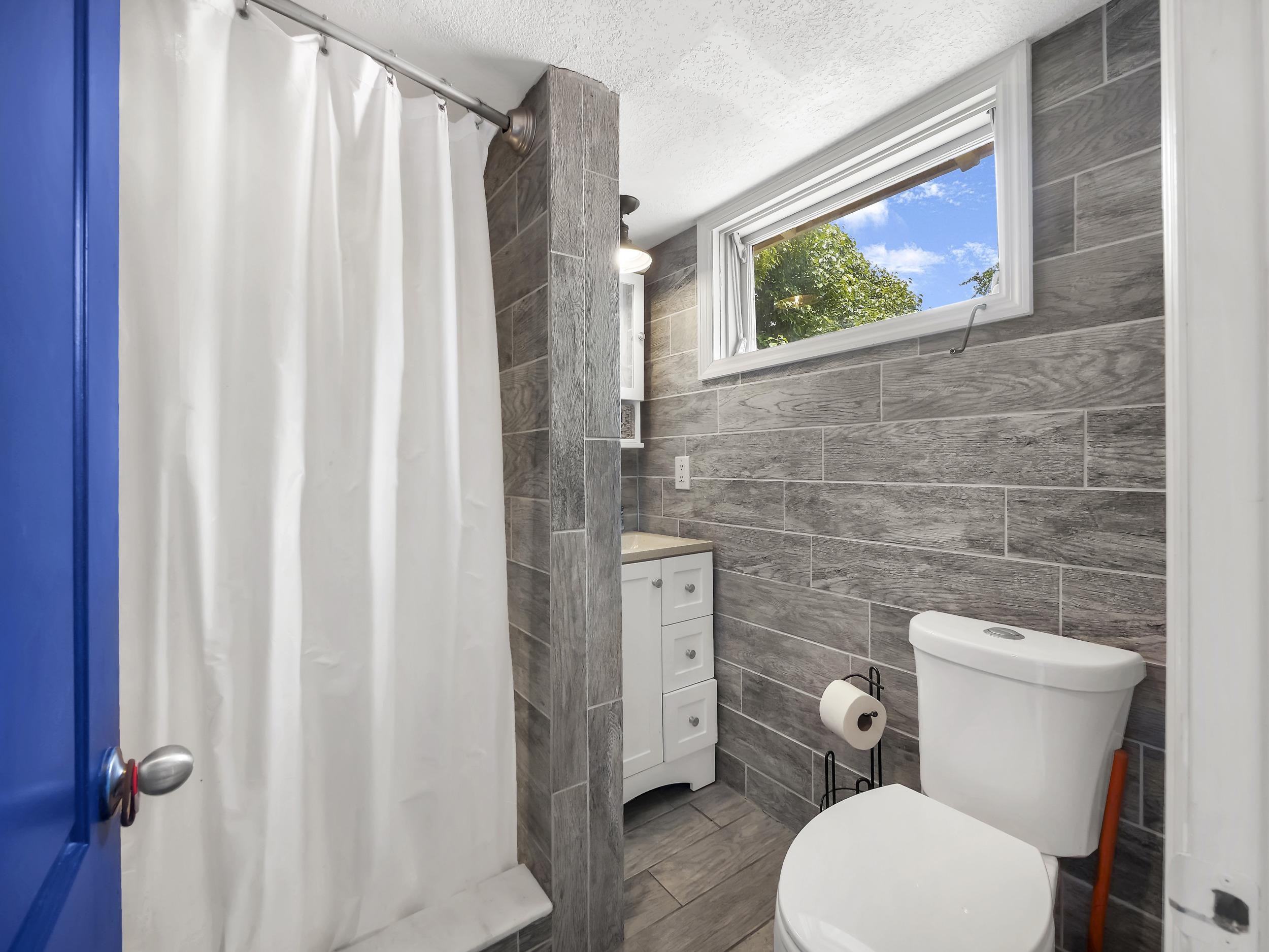 8 Davis Street St. Augustine, FL 32084 - Photo 31 of 36 a white toilet sitting next to a bathroom sink