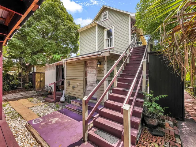 a backyard of a house with table and chairs