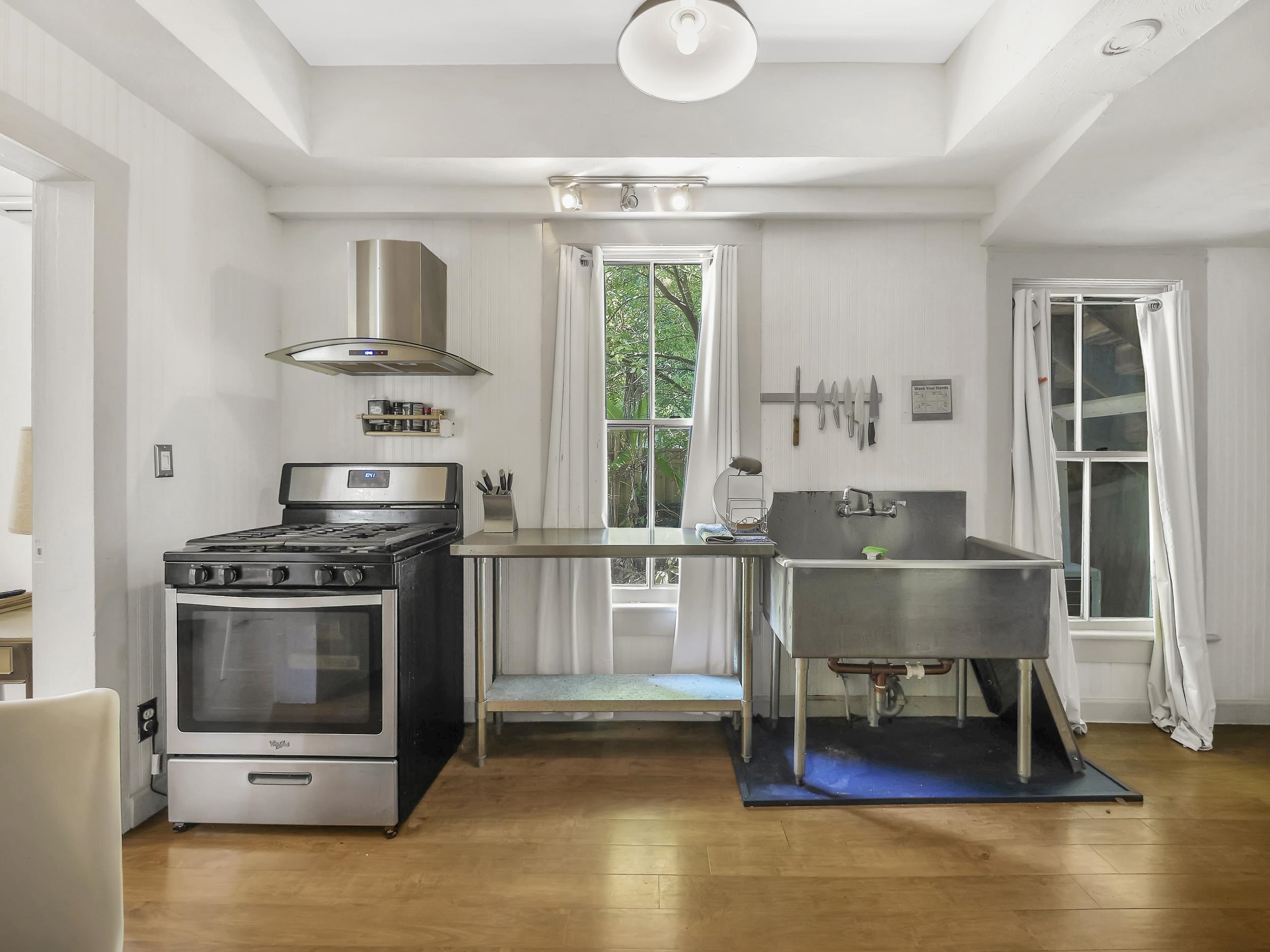 8 Davis Street St. Augustine, FL 32084 - Photo 9 of 36 a kitchen with a stove a refrigerator and a dining table