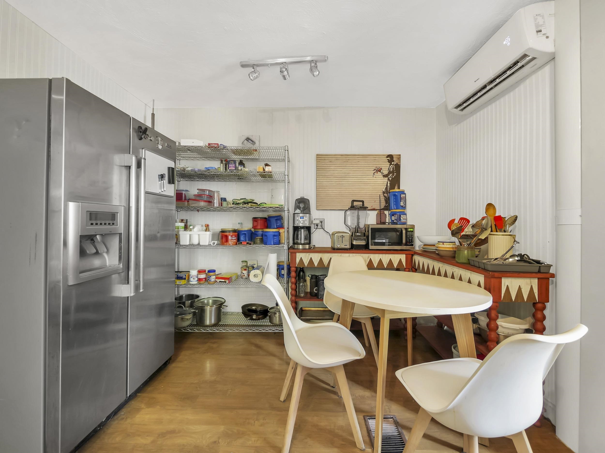 8 Davis Street St. Augustine, FL 32084 - Photo 10 of 36 a utility room with stainless steel appliances a table and chairs