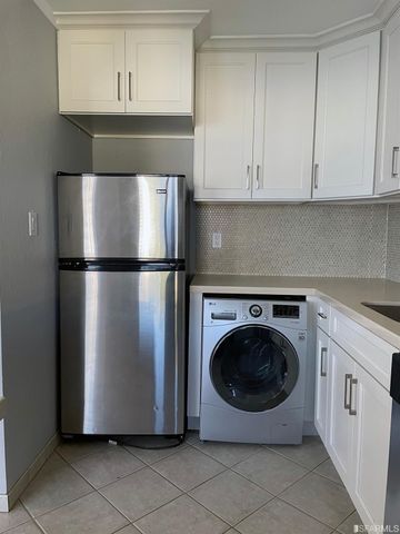 a utility room with wooden floor washer and dryer