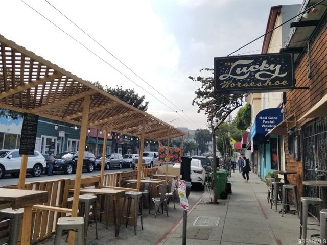 a view of city with the shops and fruits market