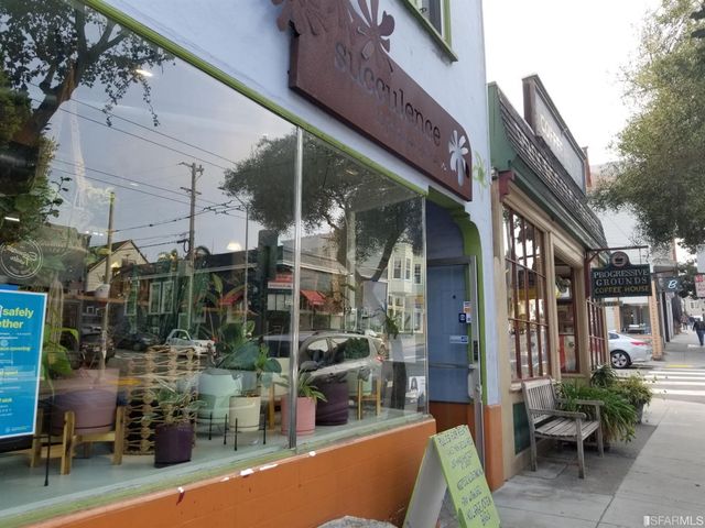 a view of path along with retail shop and buildings