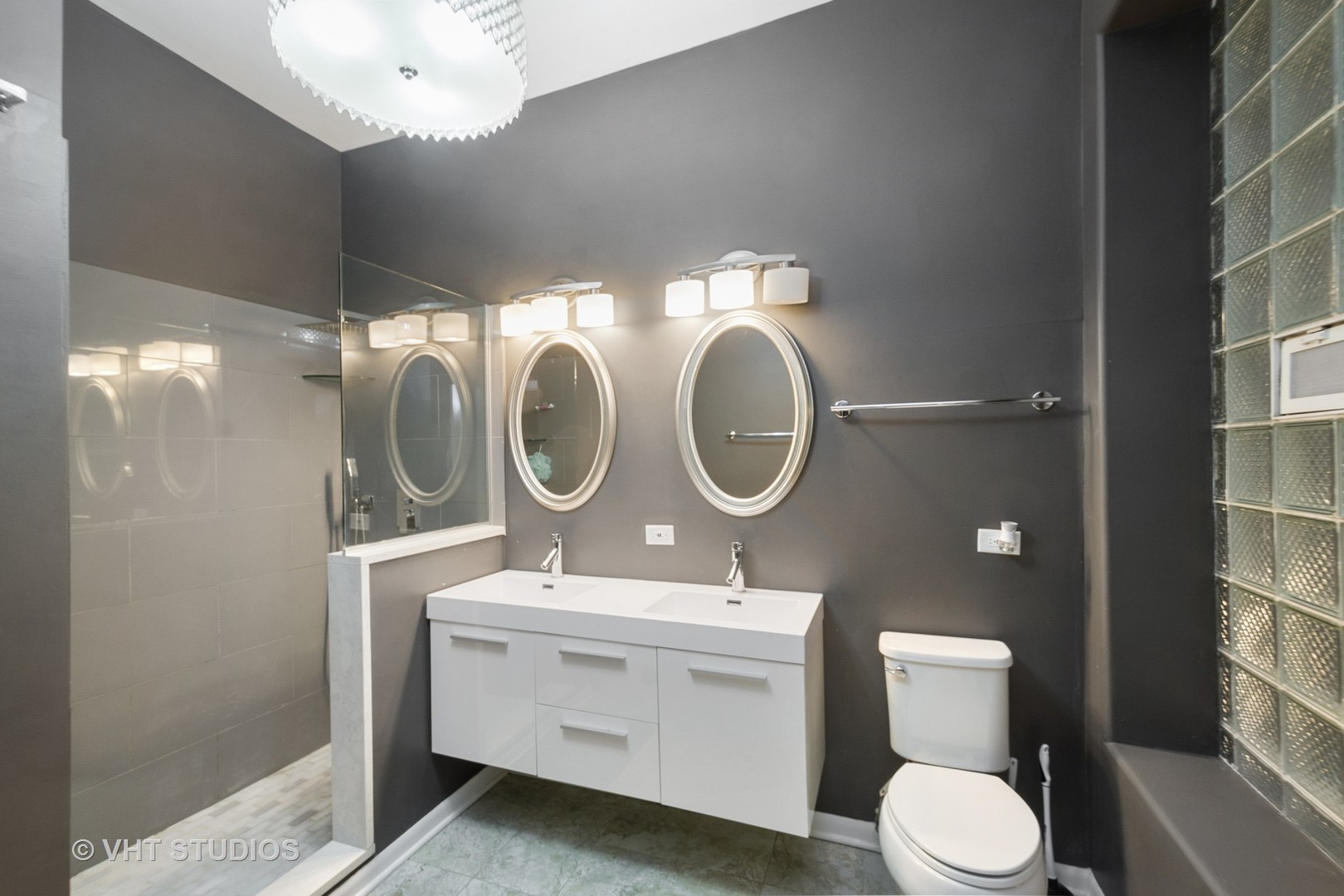 4530 South Prairie Avenue, Unit 1N Chicago, IL 60653 - Photo 6 of 11 a bathroom with a toilet a sink and a mirror