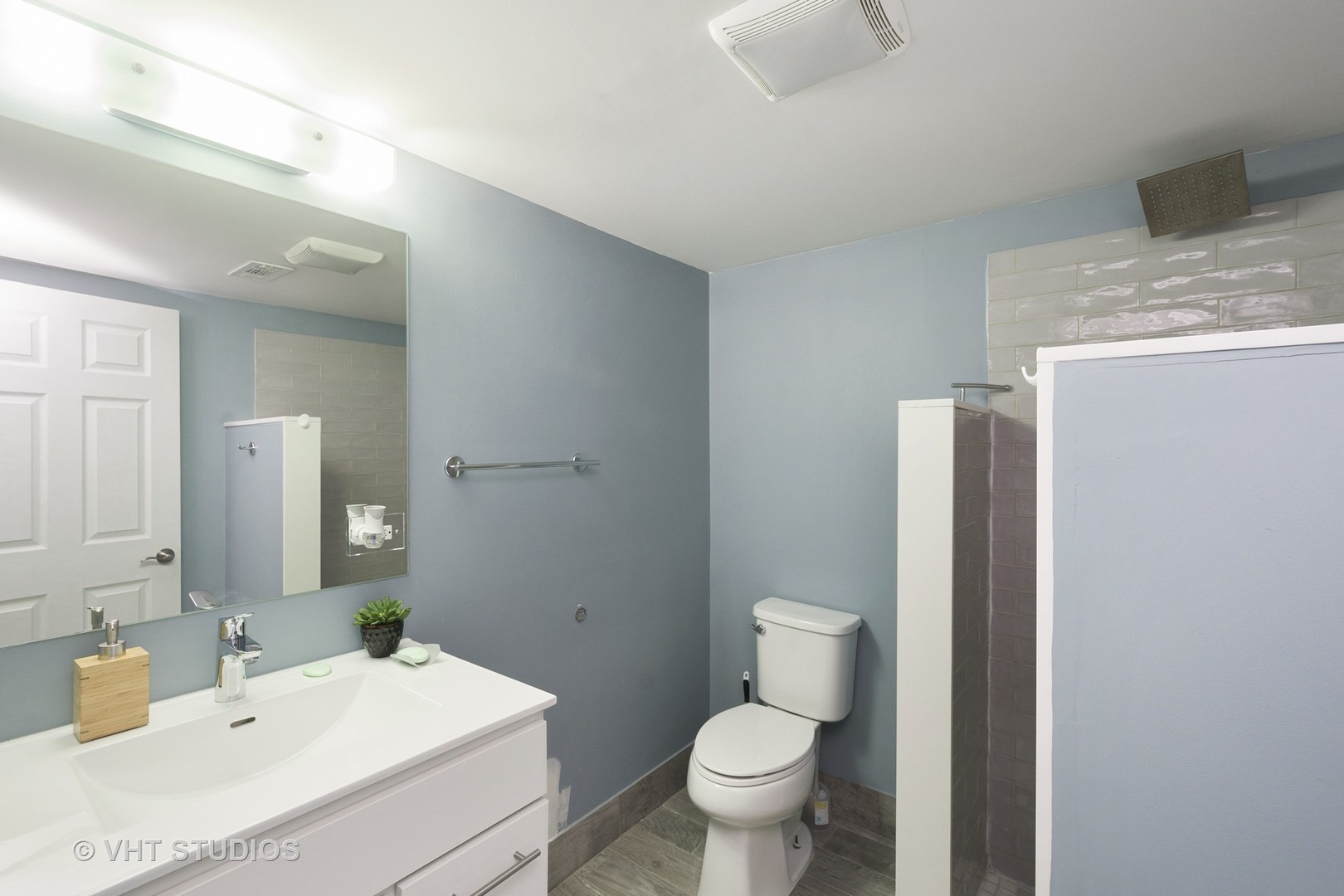 4530 South Prairie Avenue, Unit 1N Chicago, IL 60653 - Photo 10 of 11 a bathroom with a sink toilet and mirror