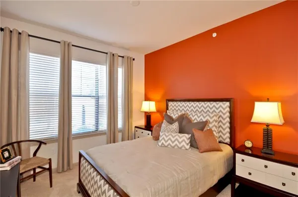 a bedroom with a bed and a lamp