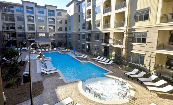 a view of a swimming pool with sitting area