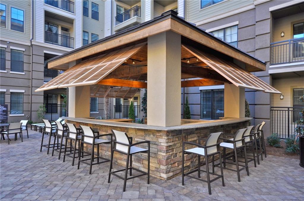 3695 Cumberland Boulevard Southeast, Unit 1129 Atlanta, GA 30339 - Photo 25 of 34 a patio with table and chairs