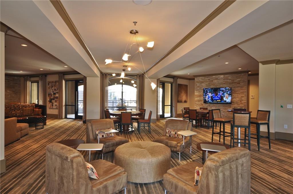 3695 Cumberland Boulevard Southeast, Unit 1129 Atlanta, GA 30339 - Photo 32 of 34 a living room with lots of furniture and a flat screen tv