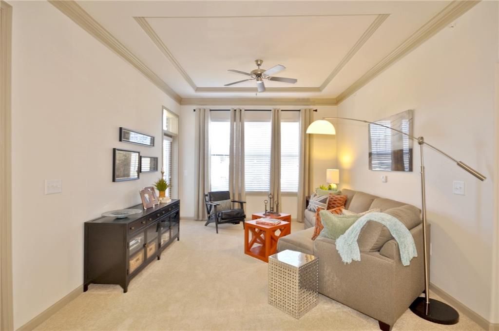 3695 Cumberland Boulevard Southeast, Unit 1129 Atlanta, GA 30339 - Photo 6 of 34 a living room with furniture and a large window