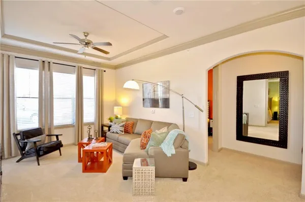 a living room with furniture and large windows