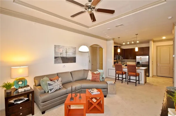 a living room with furniture and kitchen view