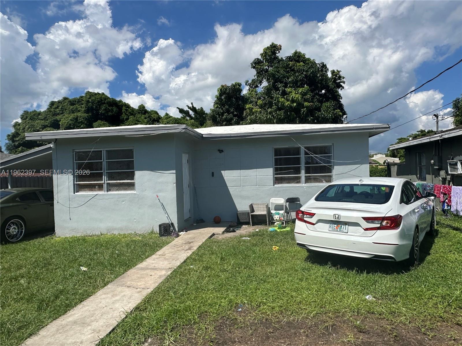 10229 Southwest 175th Street Miami, FL 33157 - Photo 1 of 7 a house view with a garden space