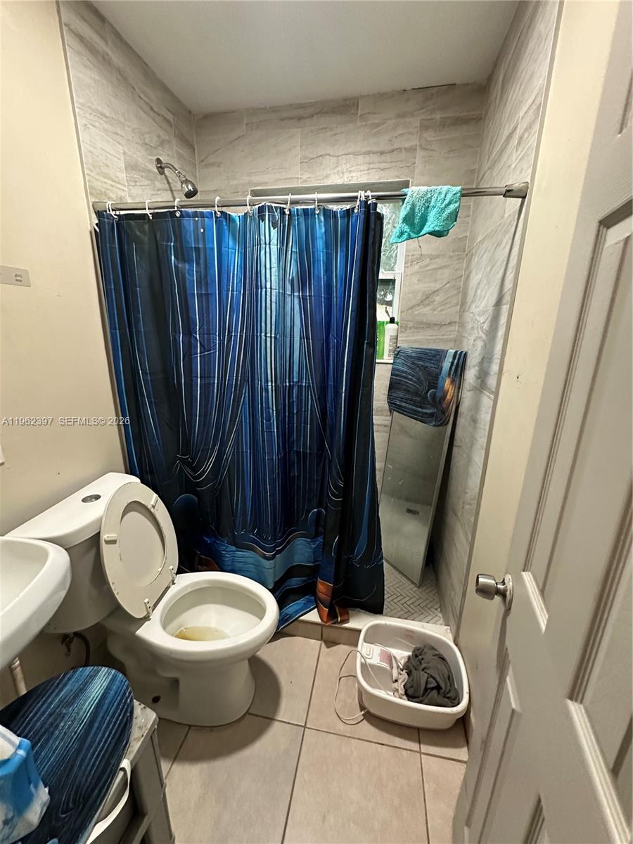 10229 Southwest 175th Street Miami, FL 33157 - Photo 5 of 7 a bathroom with a toilet and a shower