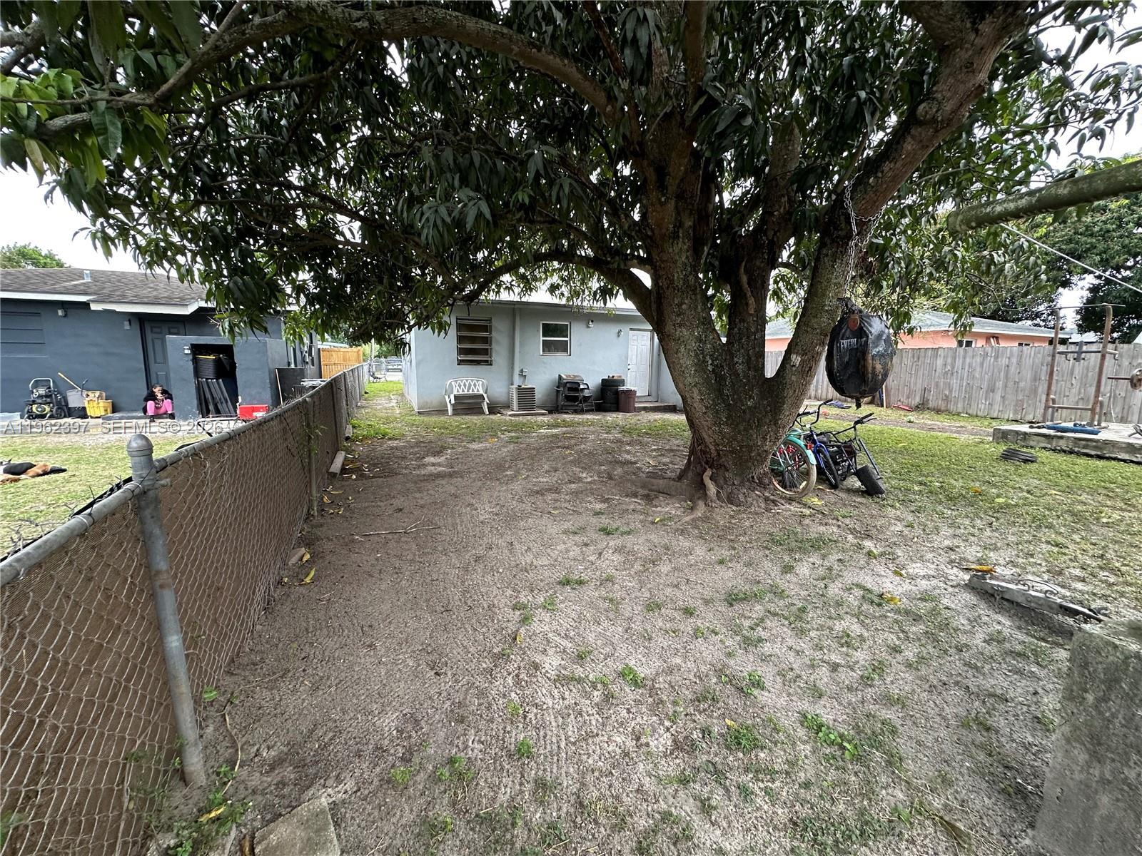 10229 Southwest 175th Street Miami, FL 33157 - Photo 6 of 7 a house view with a backyard space