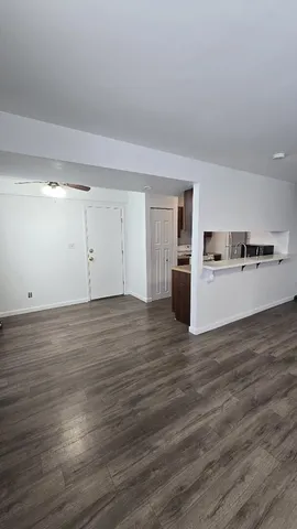 a view of a kitchen with a microwave and cabinets