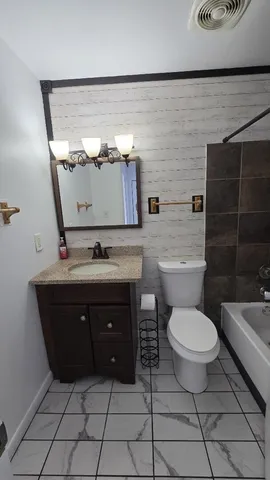 a bathroom with a toilet a sink and mirror