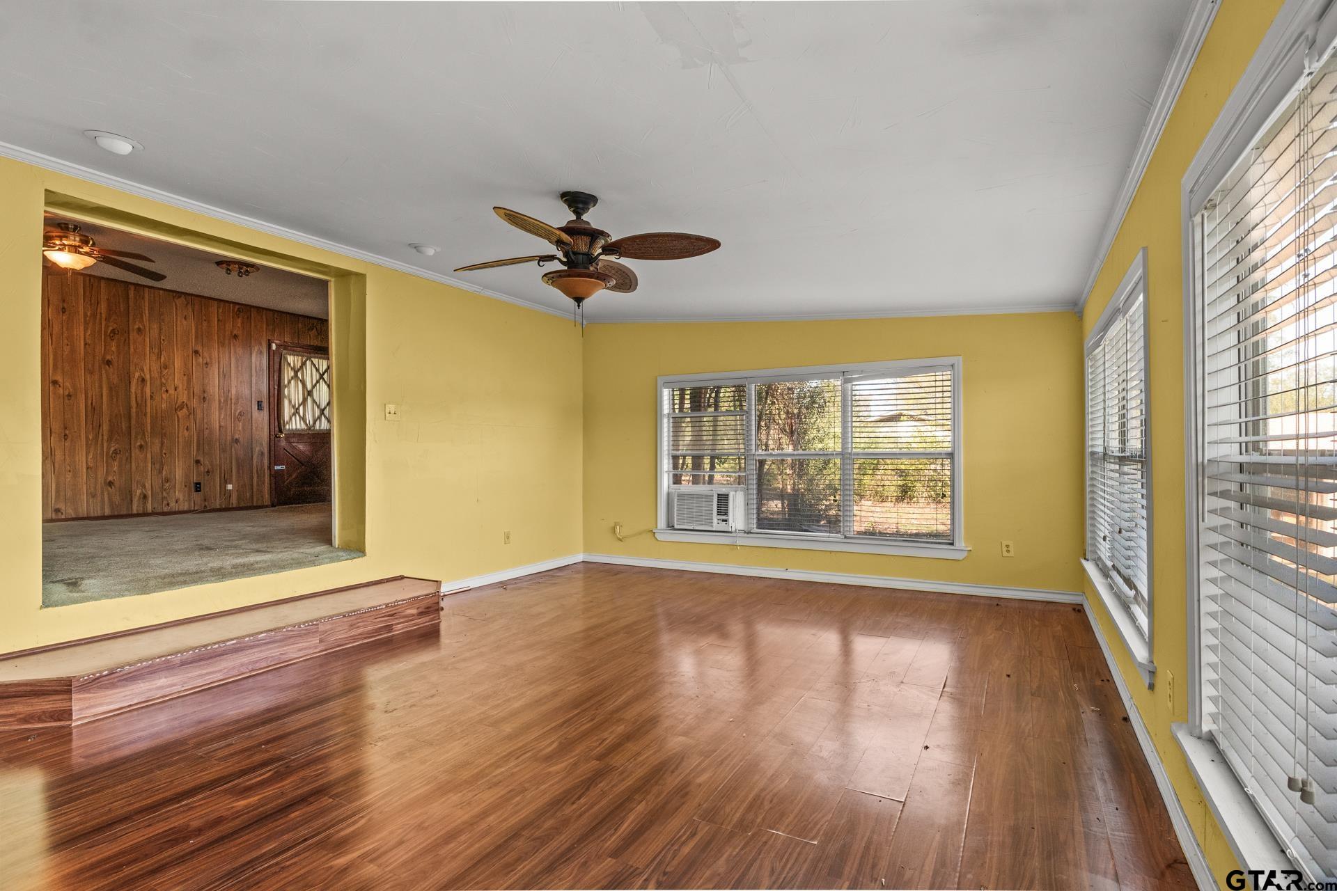302 Smith Street Naples, TX 75568 - Photo 13 of 28 a view of an empty room with wooden floor and a window