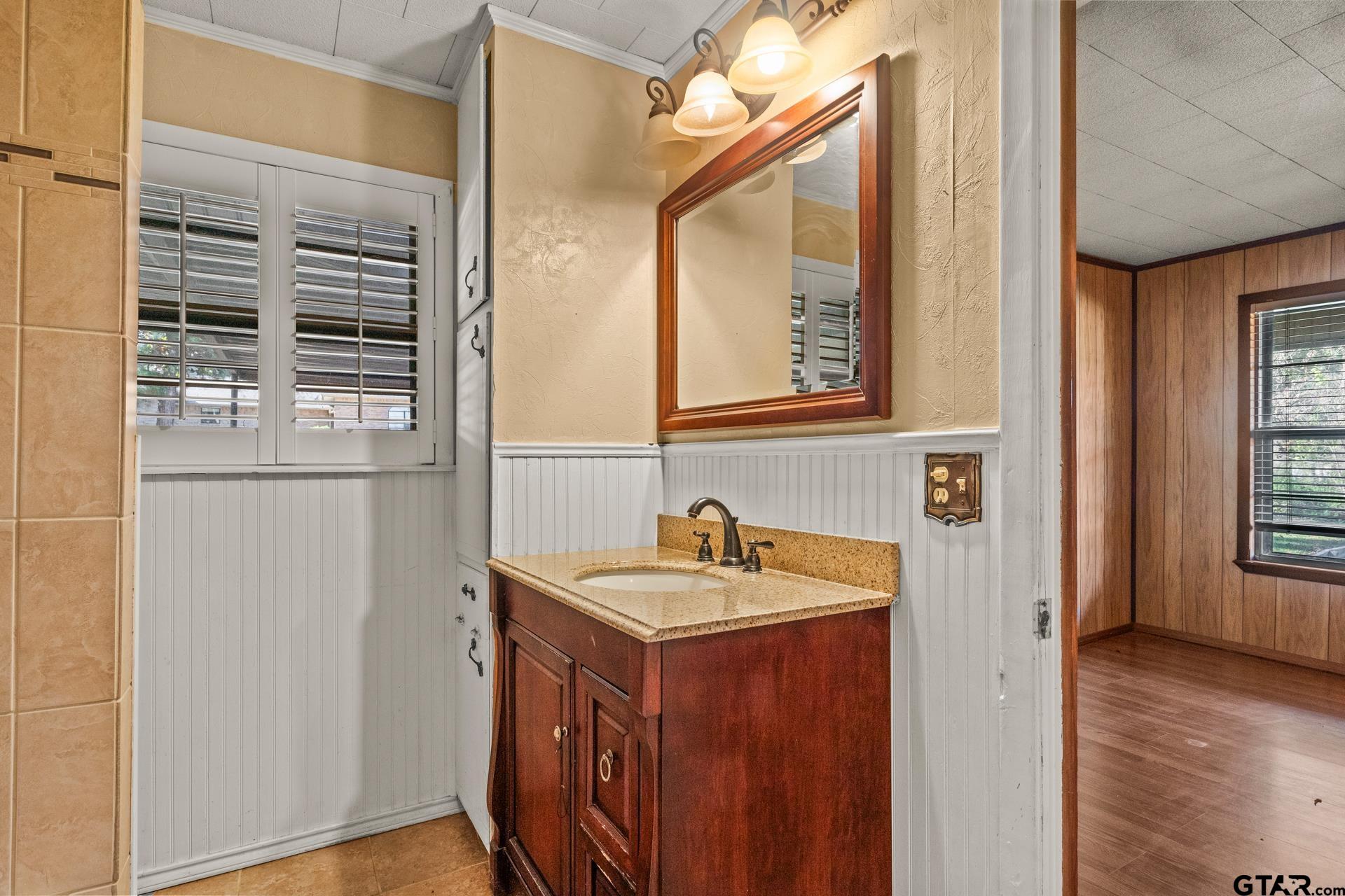 302 Smith Street Naples, TX 75568 - Photo 22 of 28 a bathroom with a sink and a mirror