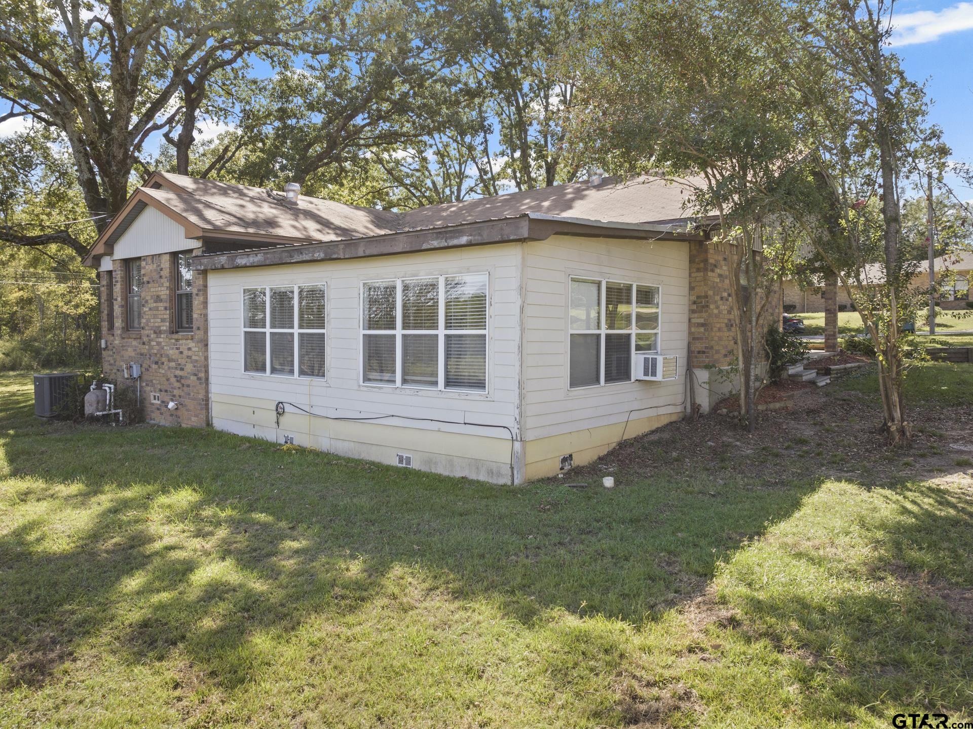 302 Smith Street Naples, TX 75568 - Photo 24 of 28 a view of a house with a yard