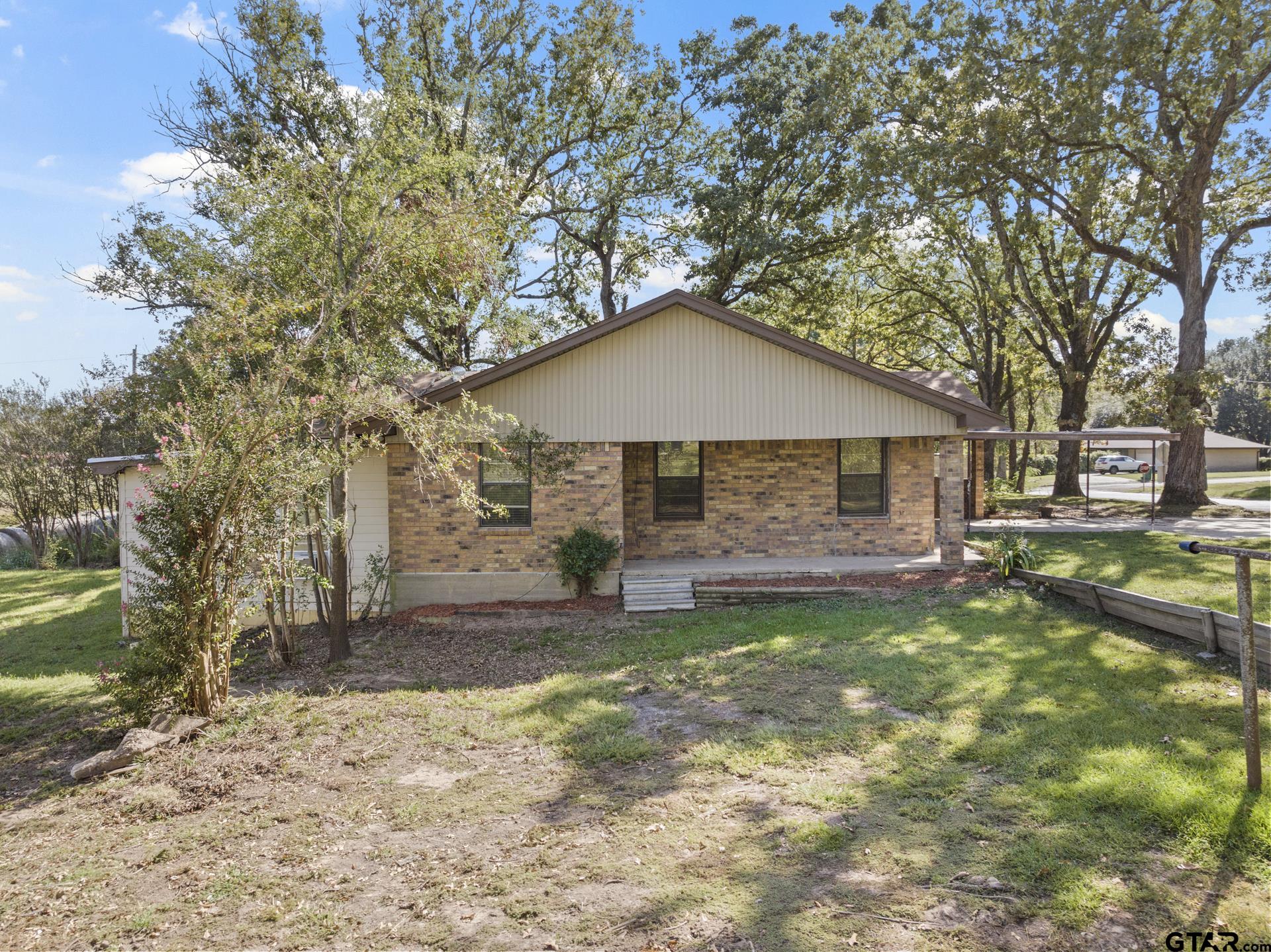 302 Smith Street Naples, TX 75568 - Photo 26 of 28 a front view of a house with a yard