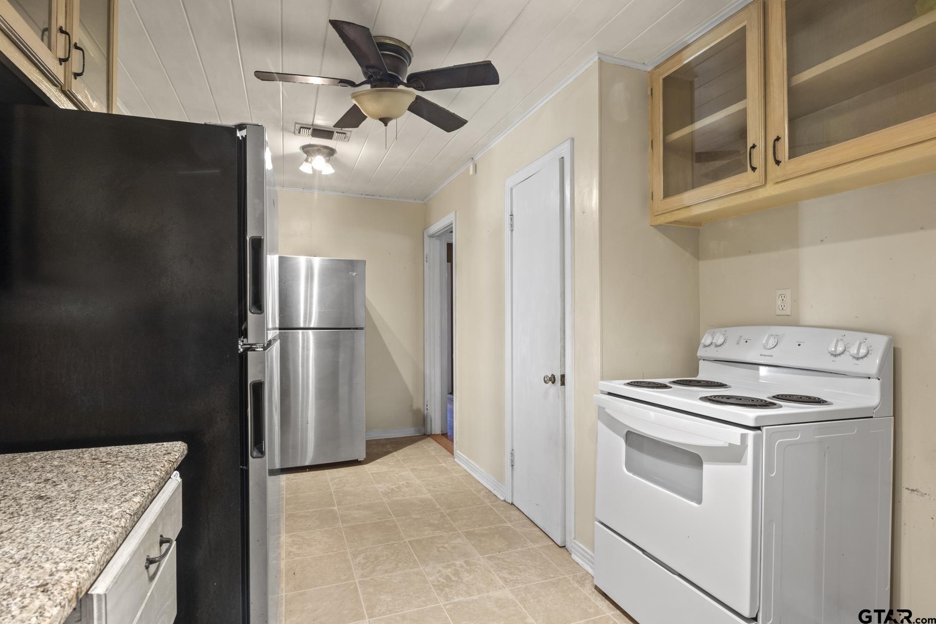 302 Smith Street Naples, TX 75568 - Photo 3 of 28 a kitchen with a stove cabinets and refrigerator