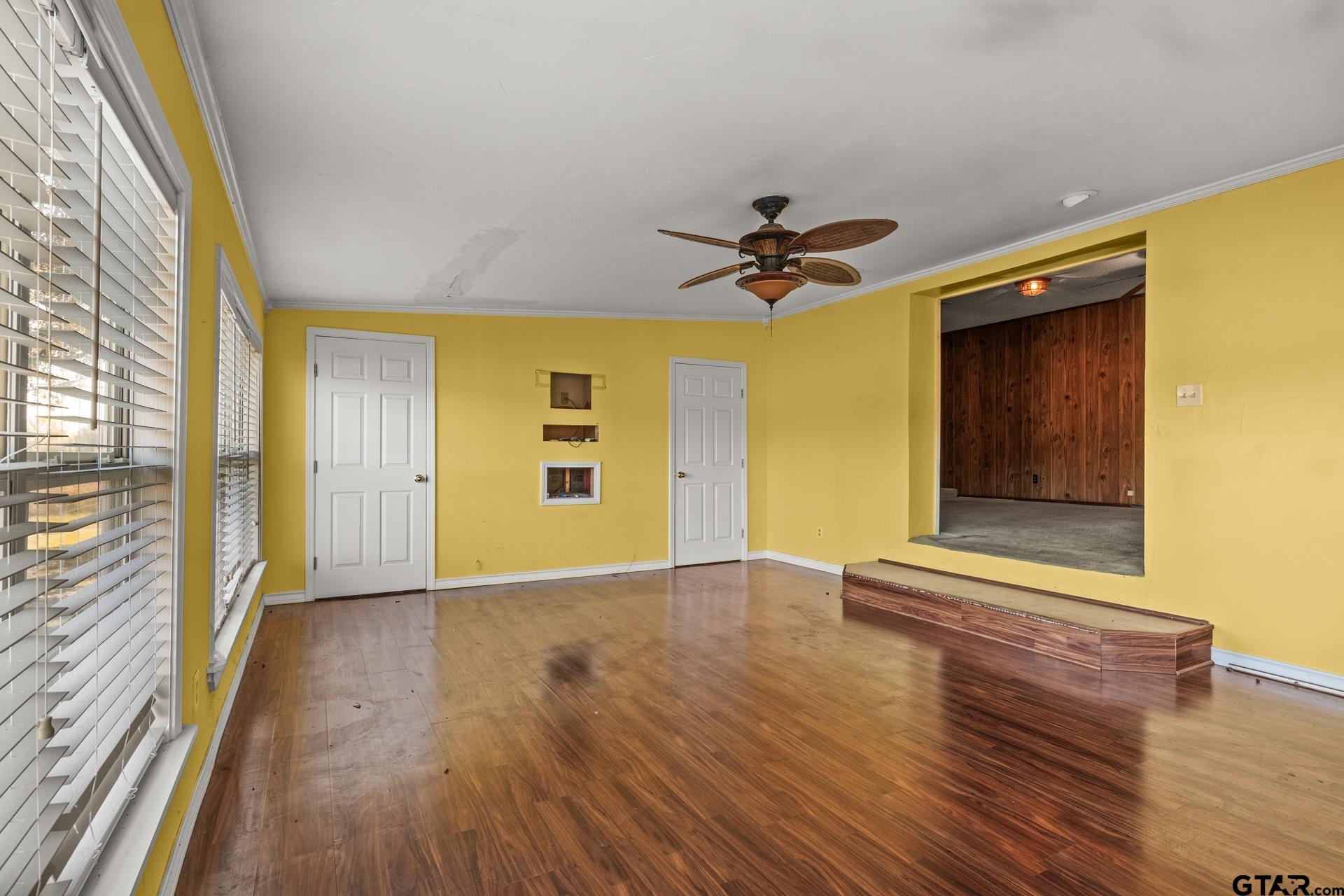 302 Smith Street Naples, TX 75568 - Photo 7 of 28 a view of a hallway with wooden floor and a fireplace