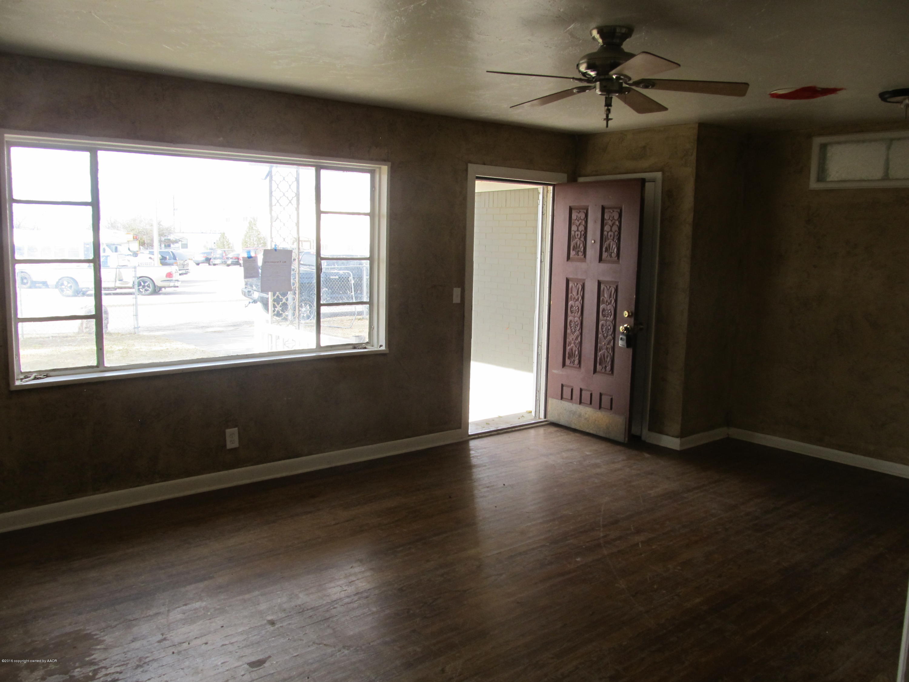 4103 South Bonham Street Amarillo, TX 79110 - Photo 1 of 13 an empty room with wooden floor and windows
