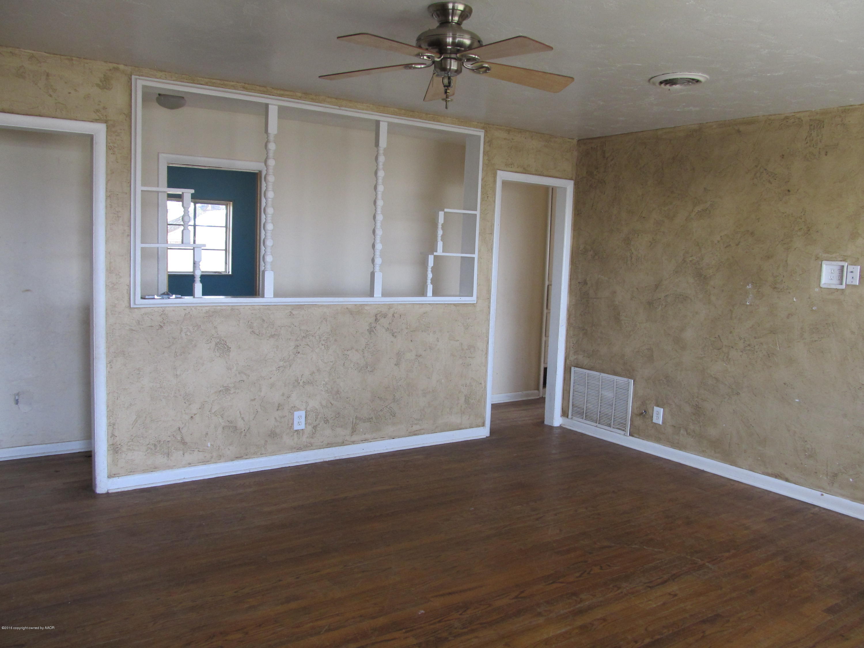 4103 South Bonham Street Amarillo, TX 79110 - Photo 3 of 13 an empty room with wooden floor and windows