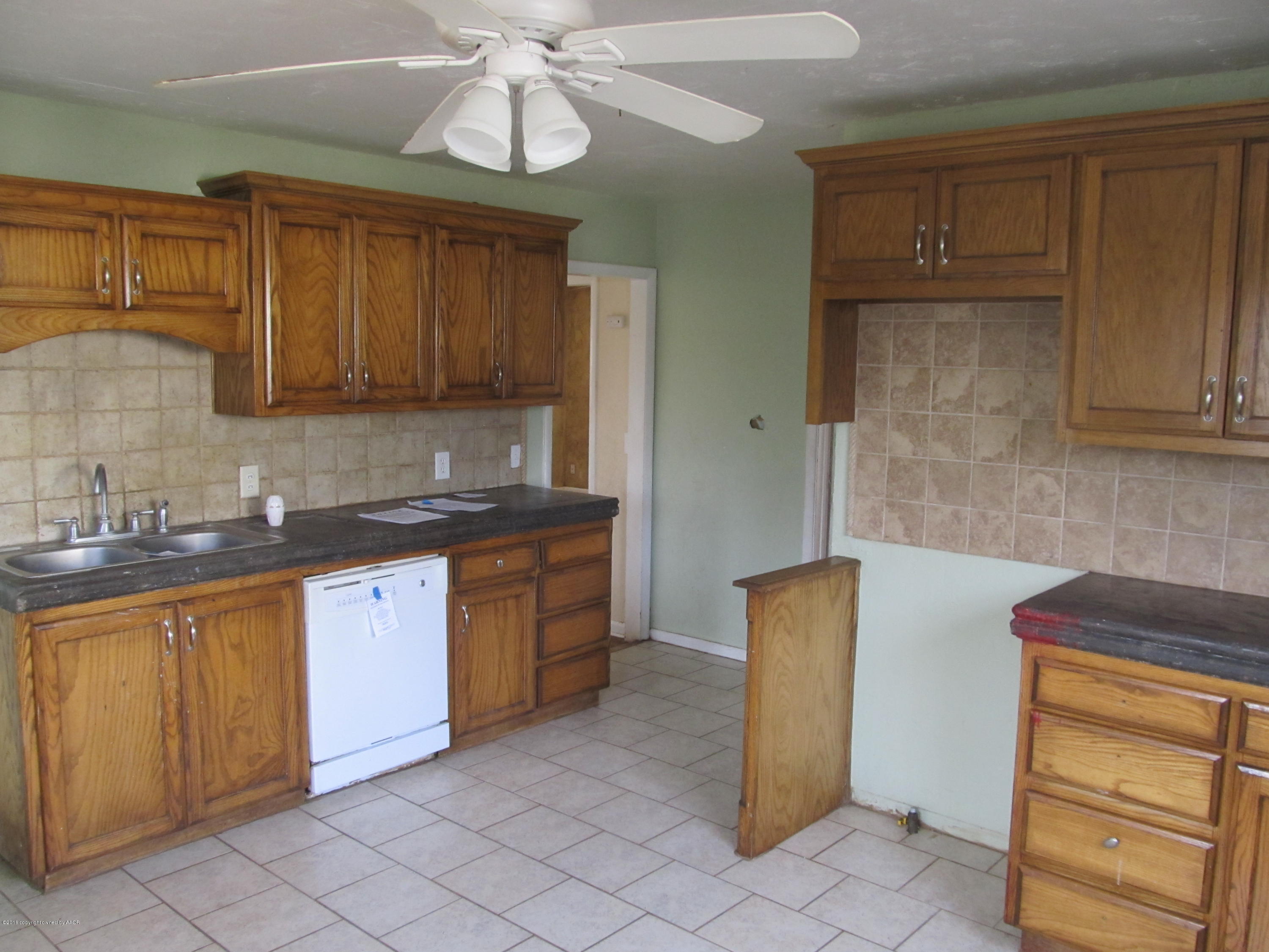 4103 South Bonham Street Amarillo, TX 79110 - Photo 5 of 13 a kitchen with granite countertop cabinets and stainless steel appliances