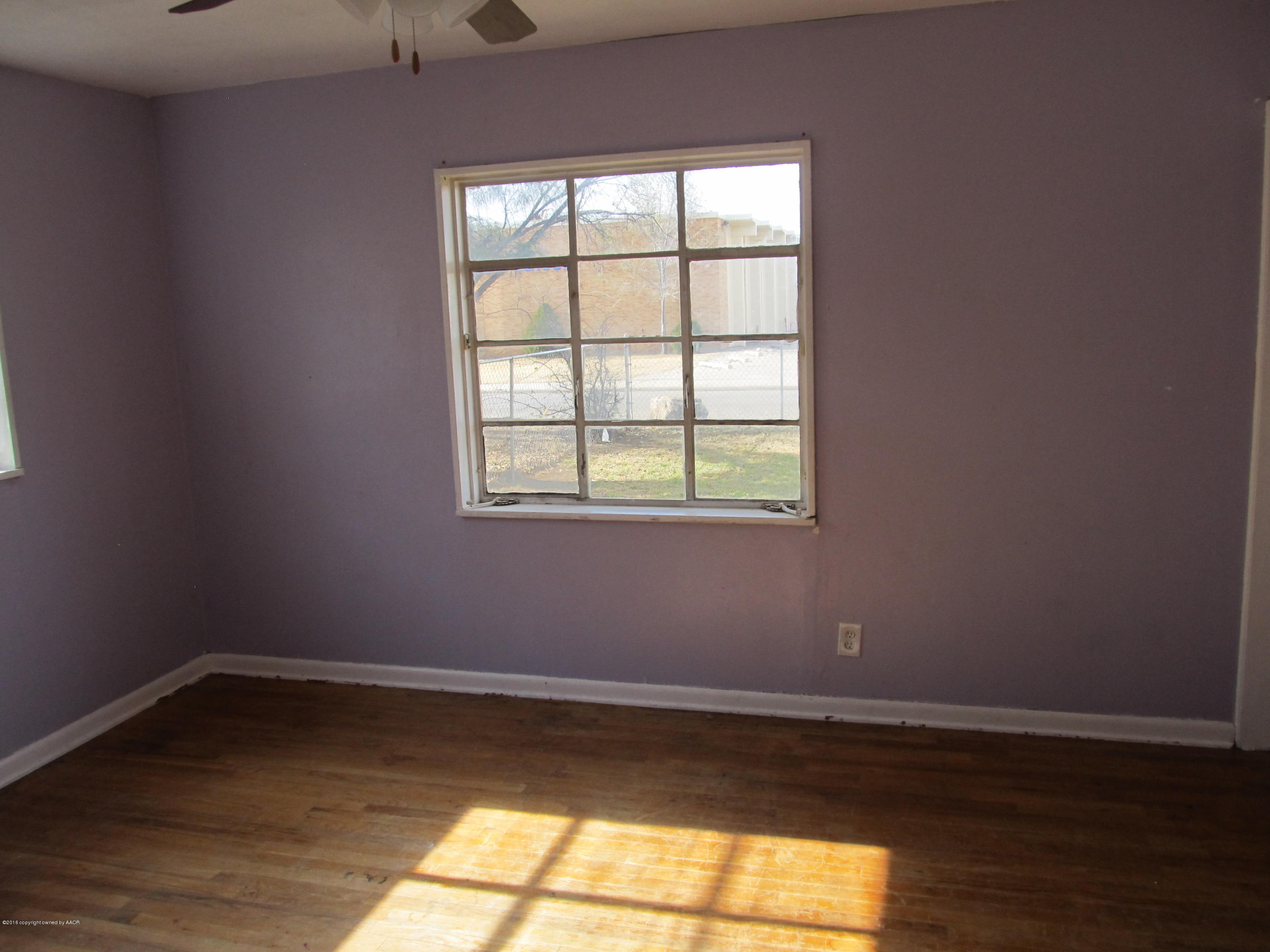 4103 South Bonham Street Amarillo, TX 79110 - Photo 6 of 13 a view of a room with wooden floor and a window